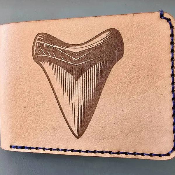 Shark tooth engraved on leather wallet